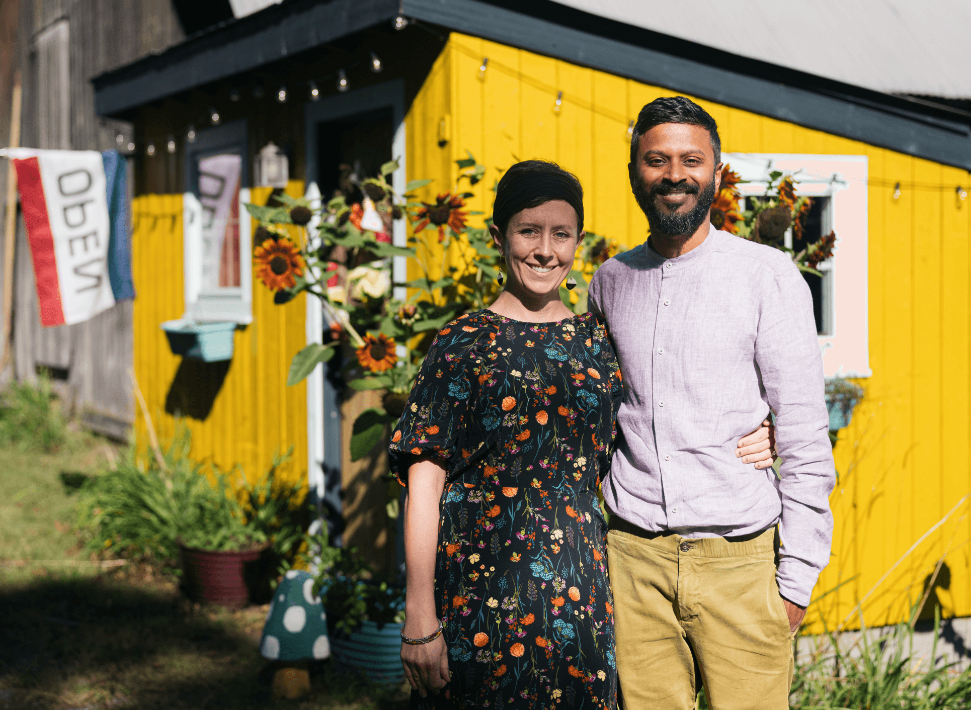 Liz and Nachi in front of the farm stand